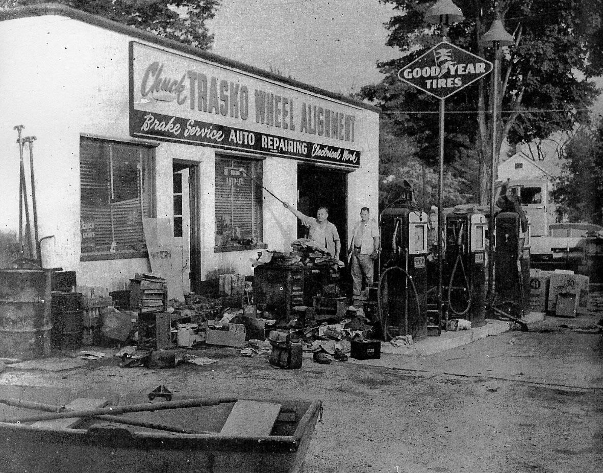A man point to the water line during the flood on a building
