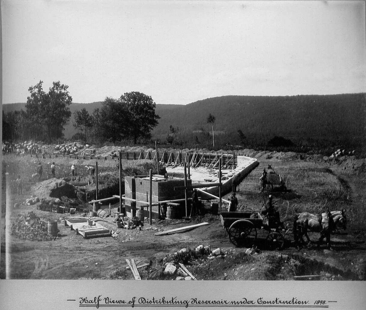 Men excavating and using horses with wagons